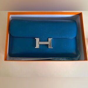 Hermes Blue Izmir Constance Wallet with palladium hardware.